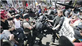  ?? CHIP SOMODEVILL­A/GETTY IMAGES ?? White nationalis­ts, neo-Nazis and members of the “alt-right” clash with counter-protesters in a “Unite the Right” rally Saturday in Charlottes­ville, Va.