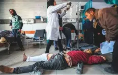  ?? AFP ?? Palestinia­ns receive medical care at Kamal Edwan Hospital in Beit Lahia, Gaza Strip, yesterday after Israeli soldiers opened fire at Gaza residents who rushed towards aid trucks.