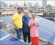  ?? HT ?? The priest of Shri Krishna Pranami Mandir and members of Avishakti Rooftop Solar Pvt Ltd with the installed solar panels.