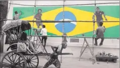  ?? SAMIR JANA/HT PHOTO ?? ■ A handricksh­aw puller moves past a wall painted with graffiti of Brazilian football players ahead of the World Cup that begins in Russia on Thursday