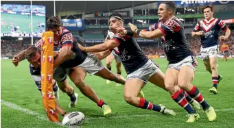  ?? PHOTOS: GETTY IMAGES ?? With inch-perfect timing, Kyle Feldt of the Cowboys scores in the corner against the Sydney Roosters during the visitors’ win which booked their spot in the NRL grand final.