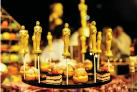  ?? Photograph: Imago/Alamy ?? Gold finger food … 24-carat chocolate Oscars at the 88th Academy Awards previews in Los Angeles in 2016.