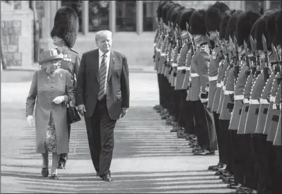  ?? The Associated Press ?? WINDSOR CASTLE: Britain’s Queen Elizabeth II and U.S. President Donald Trump inspect the Guard of Honour, during the president’s visit to Windsor Castle on Friday in Windsor, England. The monarch welcomed the American president in the courtyard of the royal castle.