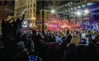  ?? BRANDEN CAMP / SPECIAL TO THE ATLANTA JOURNAL-CONSTITUTI­ON ?? Revelers celebrate early today as 2018 arrives with the Peach Drop at Woodruff Park. Thousands of people braved freezing temperatur­es for the event.