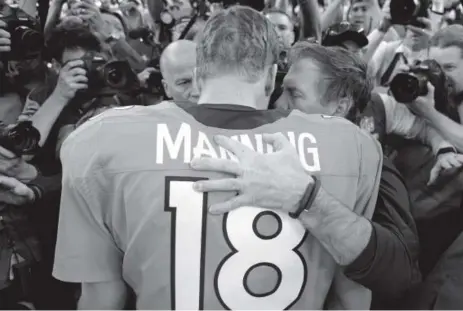  ??  ?? Broncos quarterbac­k Peyton Manning talks with Patriots coach Bill Belichick on the field in January 2014 after Denver’s 26-16 victory in the AFC championsh­ip game, propelling the Broncos to the Super Bowl. John Leyba, Denver Post file