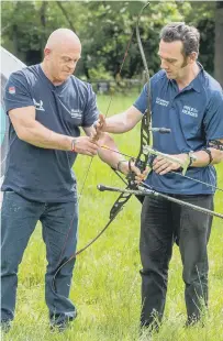  ?? ?? Jay Saunders, right, teaching archery to TV star Ross Kemp