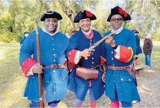  ?? JOY WALLACE DICKINSON PHOTOS ?? Volunteers, from left, including militia captain Lawson Dukes, Lloyd Mitchell and Harold Dockins, bring history to life during militia reenactmen­ts at Fort Mose Historic State Park in St. Augustine.