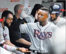  ?? Matt Marton ?? The Associated Press Tampa Bay Rays second baseman Tim Beckham, right, walks through the dugout after hitting a two-run home run during the fourth inning against Cubs starter Jon Lester on Tuesday in Chicago.