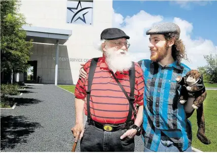  ?? Tony Bullard / For the Chronicle ?? Ken Levin, left, and son Herschel Levin, shown with his puppet, Cheekie, are father-and-son May graduates of Lone Star College-CyFair. They are both headed to Sam Houston State University to continue their educations.