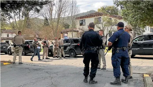  ?? AP ?? Law enforcemen­t officials gather at the Veterans Home of California after reports an active shooter had taken hostages in one of the buildings.