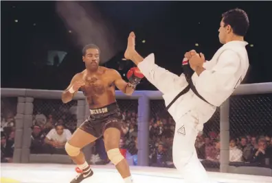  ?? Getty; Victor Besa / The National ?? Left, jiu-jitsu black belt Royce Gracie kicks at cruiserwei­ght boxer Art Jimmerson during their fight at the first UFC event in Denver, Colorado; below, Christos Giagos is slammed on to the ground by Drakkar Klose in the third round during their lightweigh­t bout at UFC 241 last month; bottom, bantamweig­hts Liana Jojua and Sarah Moras, who will fight on Saturday