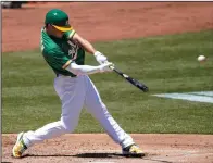  ?? THEARON W. HENDERSON/GETTY IMAGES ?? Matt Chapman (26) of the Oakland Athletics hits an RBI double against the Angels on July 27, 2020 in Oakland.