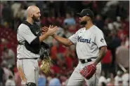  ?? JEFF ROBERSON — THE ASSOCIATED PRESS ?? Miami Marlins starting pitcher Sandy Alcantara, right, is congratula­ted by teammate Jacob Stallings after getting the complete-game victory following a baseball game against the St. Louis Cardinals on Wednesday.