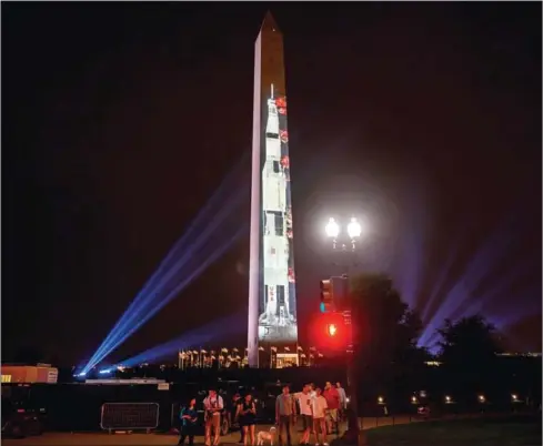  ?? ANDREW CABALLERO-REYNOLDS/AFP ?? An image of Saturn V, the rocket that sent Apollo 11 into orbit on July 16, 1969, is projected on the Washington monument in Washington, DC on Tuesday, in honour of the 50th anniversar­y of Apollo 11 and when man first walked on the moon.