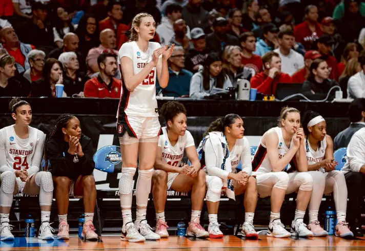  ?? Photos by Stephen Lam/The Chronicle ?? Stanford forward Cameron Brink was forced to cheer from the bench after she was fouled out during the fourth quarter. Brink, a first-team All-American this season, played her last collegiate game. Brink had five of her seven blocks in the first quarter.