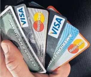  ?? ELISE AMENDOLA/THE ASSOCIATED PRESS FILE PHOTO ?? Canadians have racked up credit-card debt to go with lines of credit, mortgages and car loans.