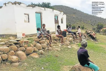  ?? SUPPLIED Picture: ?? DESPERATE: Children sit outside a damaged house. The department of human settlement­s has promised to rebuild the houses before Christmas.