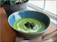  ??  ?? EatNic’s spring pea soup features mint, morels and crème fraîche.