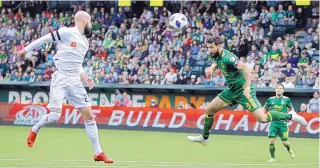  ?? SEAN MEAGHER/THE OREGONIAN VIA AP ?? Portland’s Diego Valeri (8) tries a header against Los Angeles FC on Saturday. The Timbers improved to 4-0 at home with a 2-1 victory.