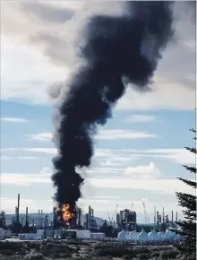  ?? NATE GUIMOND CANADIAN PRESS HANDOUT ?? A fire and plume of smoke rise from an Irving Oil refinery after an explosion Monday. Most of the facility was shut down for maintenanc­e.