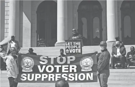  ?? MATTHEW DAE SMITH/LANSING STATE JOURNAL VIA AP ?? The Rev. Kenneth Pierce of the Detroit Branch NAACP and pastor at Hopewell Missionary Baptist Church addresses a rally for voting rights last week at the Capitol in Lansing, Mich. In Georgia, faith leaders are asking corporate executives to condemn laws restrictin­g voting access or face a boycott.