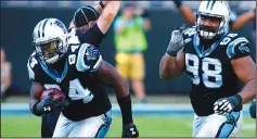  ?? JEFF SINER/TRIBUNE NEWS SERVICE ?? Carolina Panthers defensive end Kony Ealy, left, cradles the ball after intercepti­ng a pass against the Arizona Cardinals on October 30, 2016 in Charlotte, N.C. Ealy joined the Raiders this week.