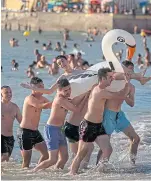  ?? Picture: AP. ?? Bathers enjoy the beach in Cadiz on Friday.