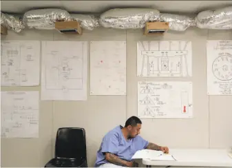  ?? Carlos Avila Gonzalez / The Chronicle ?? Inmate Lawrence Cordova works on a heating and ventilatio­n project in a training program at the Central Valley Modified Community Correction­al Facility in McFarland (Kern County).