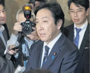  ?? AFP ?? Japan’s Trade Minister Isshu Sugawara speaks to the media at the parliament in Tokyo, yesterday.