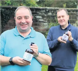  ??  ?? Dave Swarbrook, left, and artist Gavin Bowyer with the Leek Gin.