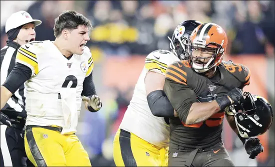  ?? (AP) ?? Cleveland Browns defensive end Myles Garrett (95) reacts after swinging a helmet at Pittsburgh Steelers quarterbac­k Mason Rudolph (2) in the fourth quarter of an NFL football game on Nov
14 in Cleveland. The Browns won 21-7.