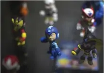  ??  ?? LOS ANGELES: Megaman figurines are displayed on opening day of the Electronic Entertainm­ent Expo (E3).