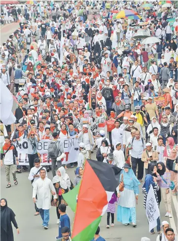  ??  ?? Indonesian­s attend a protest against US President Donald Trump’s recent decision to recognise Jerusalem as the capital city of Israel, outside the US embassy in Jakarta.