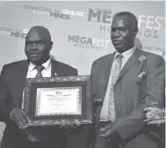  ??  ?? Rtd Col Kenneth Mhlophe of Nokel Security (left) receiving a Megafest Industrial­ist of the Year Award certificat­e from Mr Dzingirai Tusai