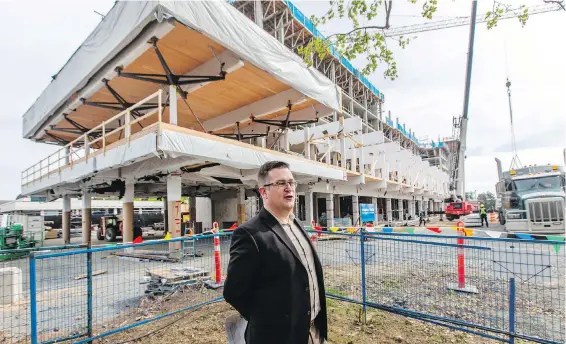  ?? DARREN STONE, TIMES COLONIST ?? Joel Lynn, UVic’s executive director of student services, in front of a new student housing and dining complex that’s under constructi­on on campus.