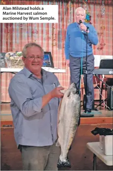  ??  ?? Alan Milstead holds a Marine Harvest salmon auctioned by Wum Semple.