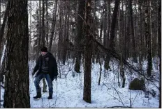  ?? (The New York Times/Maciek Nabrdalik) ?? Zygmunt Malinowski stands near a forest memorial stone (right) where Jews were killed in the early 1940s outside Malinowo, Poland. “The war ended 75 years ago, but it still lives on in our bones. It will last forever,” he said.