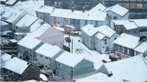  ??  ?? A car negotiates a snow-covered hill at Pontypridd
CHRIS FAIRWEATHE­R/HUW EVANS AGENCY