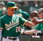  ?? Getty Images/tns ?? Matt Chapman of the Oakland Athletics celebrates after scoring on a single by Mark Canha in the bottom of the third inning against the Houston Astros at Ring Central Coliseum on Saturday.