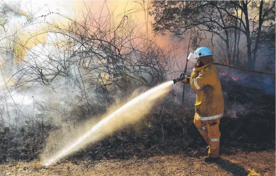  ?? Picture: EVAN MORGAN ?? HOT WORK: Alice River rural firefighte­r Stuart Linn, from Rangewood, attends a bushfire on Herveys Range Rd earlier this month.