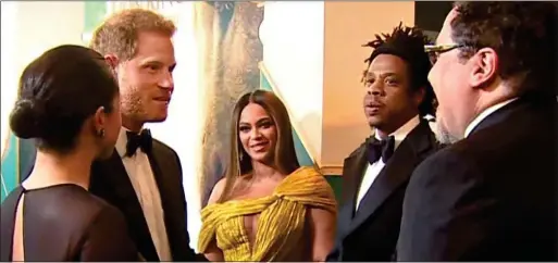  ??  ?? THE PITCH: Harry and Meghan talk to director Jon Favreau, far right, at The Lion King premiere, as star Beyoncé and her husband Jay-Z look on