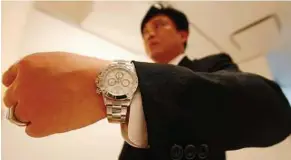  ??  ?? Luxurious timepiece: A man wearing the Rolex Daytona watch by Rolex in an auction preview at the De Sarthe gallery in Hong Kong. — EPA