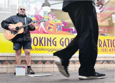  ?? PHOTO: PETER MCINTOSH ?? Strum concerns . . . Dunedin busker Jackson Caine may not be able to play in his usual spot in Albion Lane if a proposed bylaw goes ahead.