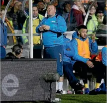  ?? PHOTO: REUTERS ?? Sutton United’s substitute goalkeeper Wayne Shaw treats himself to a pie during the FA Cup clash with Arsenal.