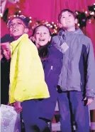  ?? AMY HERZOG/MORNING CALL FILE PHOTO ?? Faces of the season: Students from Donegan and St. Anne's elementary schools enjoy the Bethlehem tree lighting last year.