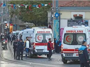  ?? (AFP) ?? Ambulances line up as Turkish policemen try to secure the area after a strong explosion of unknown origin shook the busy shopping street of Istiklal in Istanbul, on Sunday.