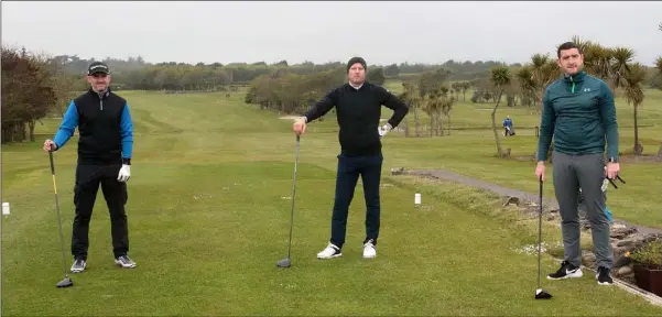  ??  ?? Adam Murphy, Conor Sinnott and Joey Wadding observing social distancing protocol before teeing off at St Helen’s Bay Golf Club, which re-opened recently.