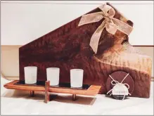  ?? PHOTO PROVIDED ?? A wooden cutting board and candle holder are displayed at Studio Sweet.