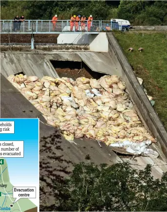  ??  ?? Stop gap measure: Bags of aggregate used to shore up the dam yesterday