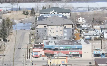  ?? VINCENT MCDERMOTT ?? Flood waters are receding in downtown Fort Mcmurray, but many evacuees could have to wait another week before returning to their home and businesses, Mayor Don Scott said Friday.